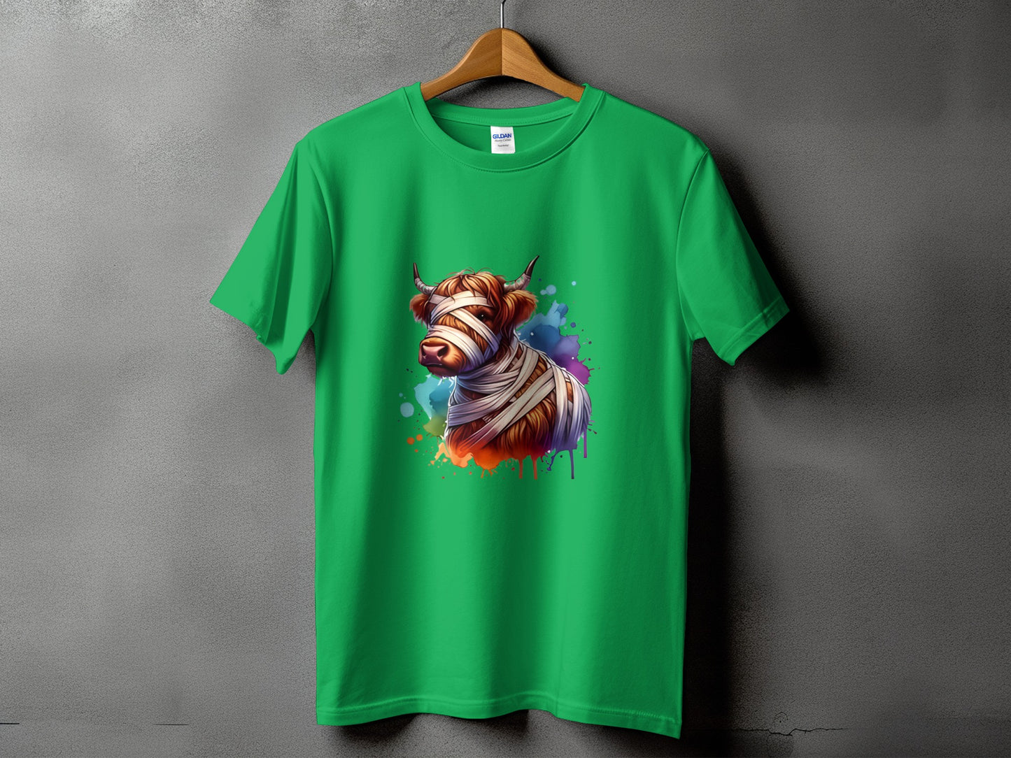 Green t-shirt with a colorful graphic of a cow bandaged like a mummy.