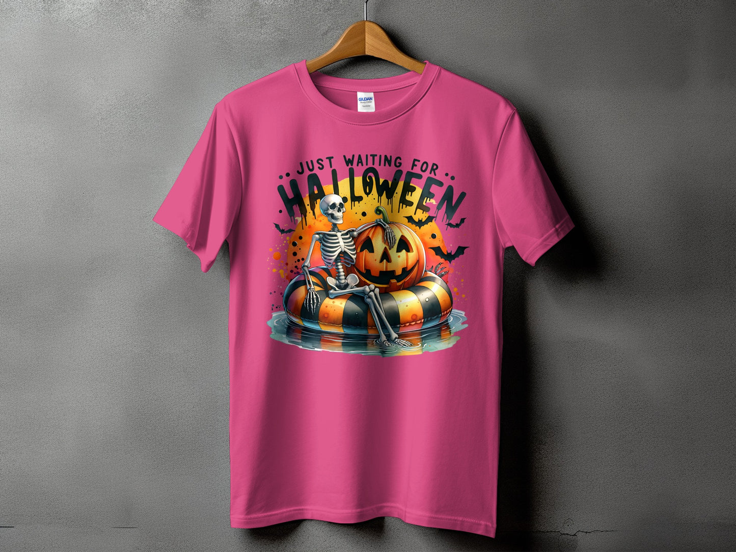 Skeleton and pumpkin float on inner tube with text "Just Waiting for Halloween".