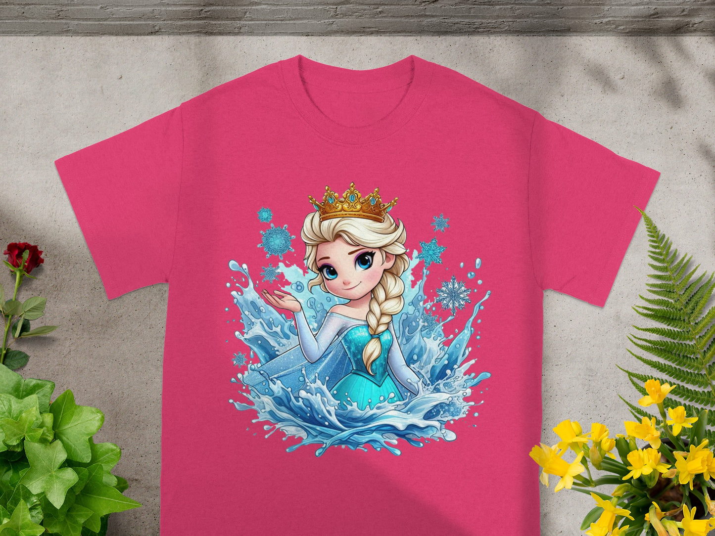 Pink t-shirt with Disney's Elsa in a blue dress surrounded by water splashes and snowflakes.
