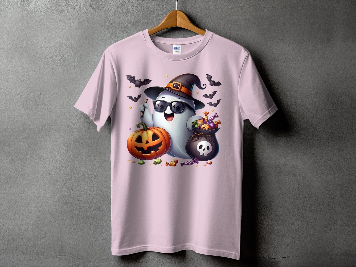 Ghost with sunglasses, witch hat, pumpkin, candy bag, and bats on a pink t-shirt.