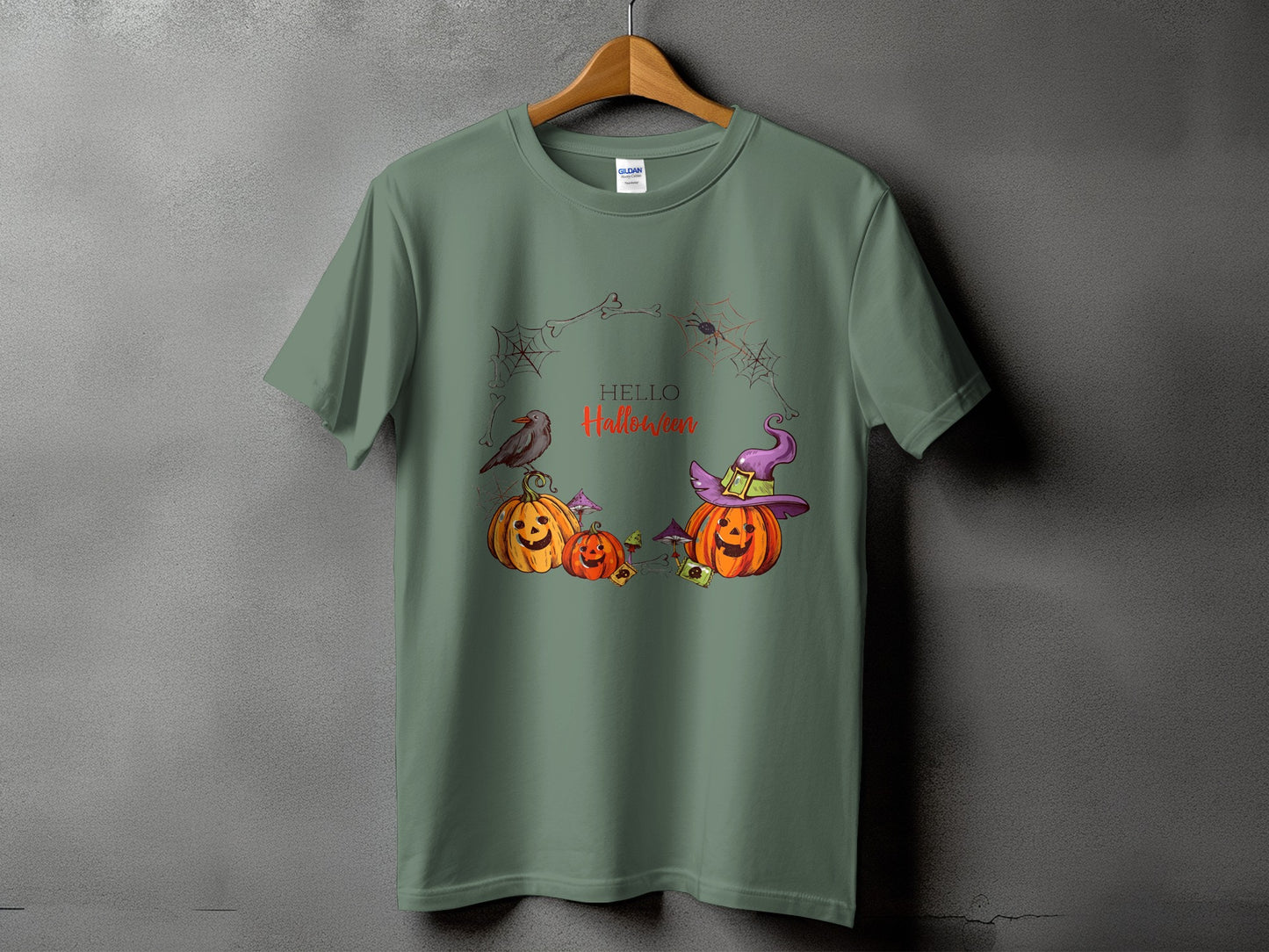 Green t-shirt with Halloween pumpkins, witch hat, spiderwebs, and "Hello Halloween" text.
