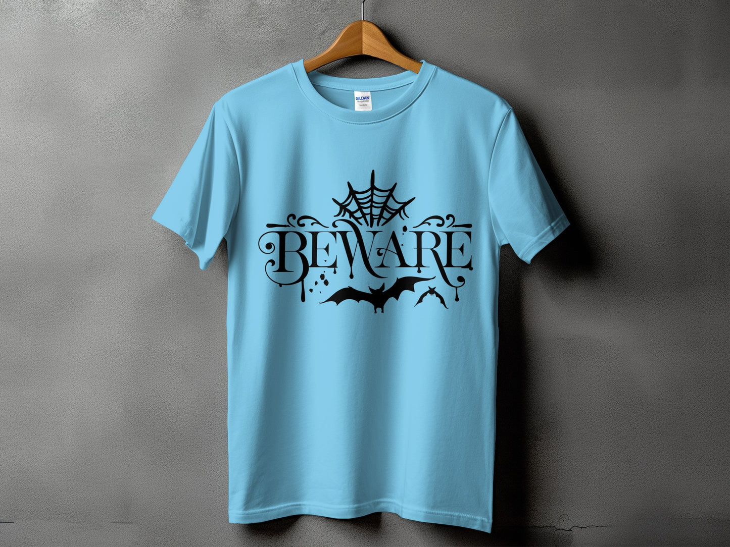 Light blue t-shirt with black "BEWARE" text, bats, and spider web graphic.