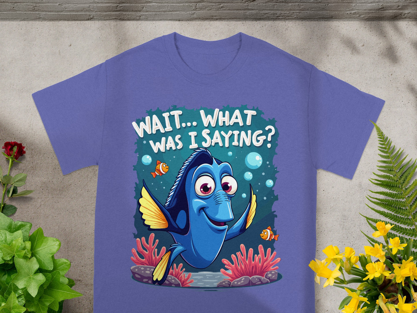 Dory from Finding Dory on a purple t-shirt saying "WAIT... WHAT WAS I SAYING?"