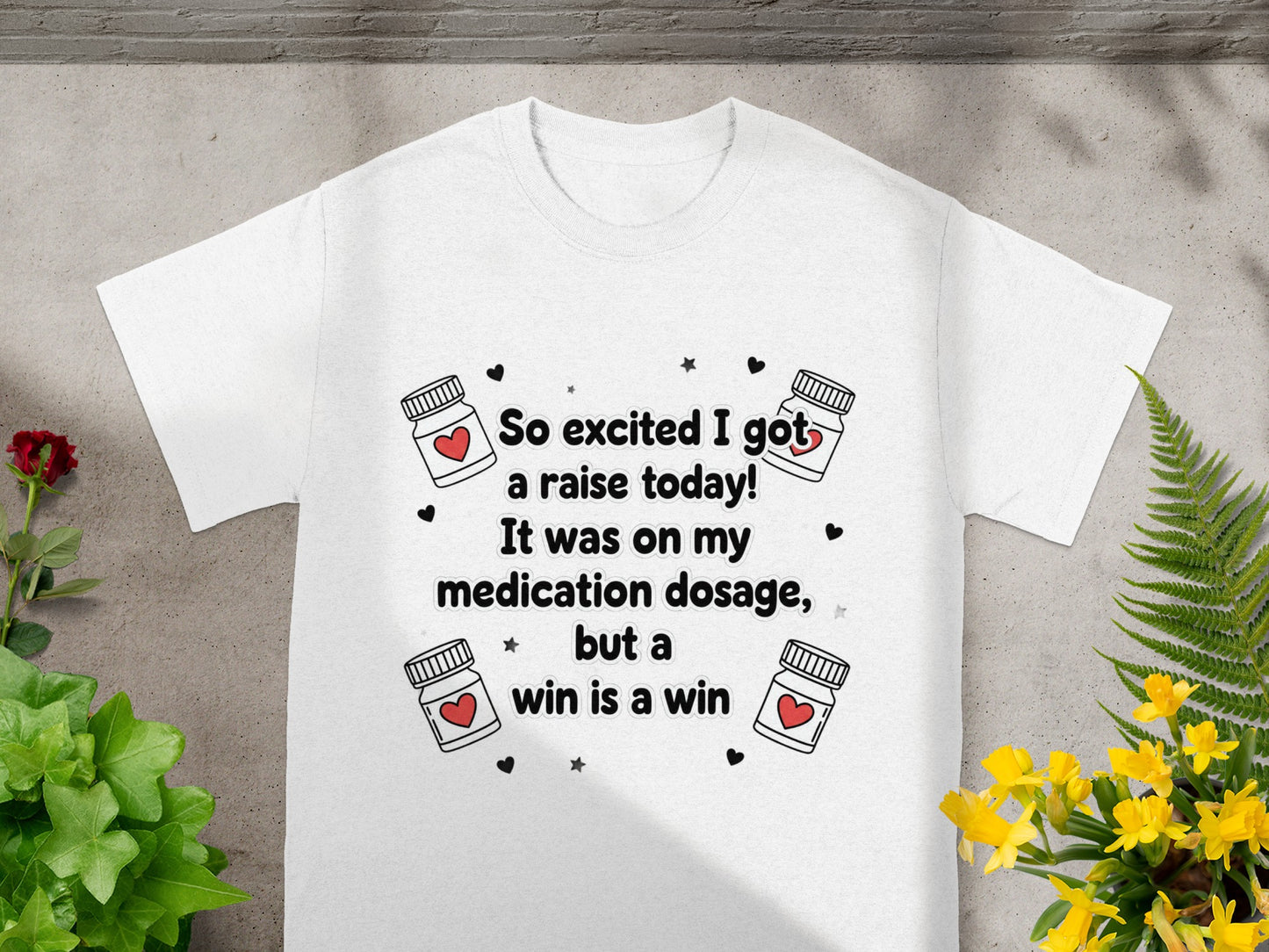 White t-shirt with "So excited I got a raise today!" text and medicine bottle graphics.