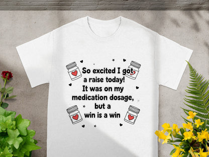 White t-shirt with "So excited I got a raise today!" text and medicine bottle graphics.