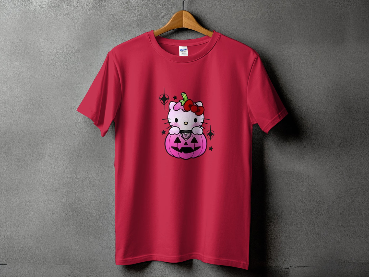 Red t-shirt with Hello Kitty sitting in a pink Halloween pumpkin.