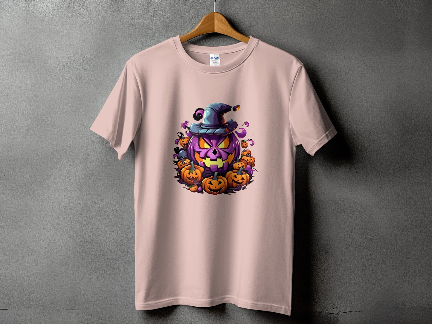 Pink t-shirt with a spooky purple jack-o'-lantern and surrounding pumpkins.