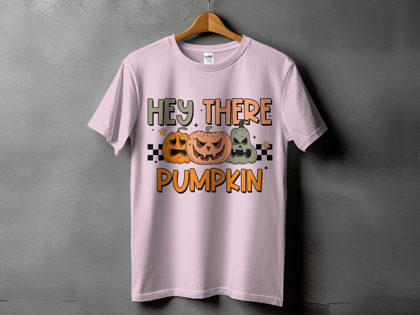 Pink t-shirt with "Hey There Pumpkin" text and three cartoon pumpkins.