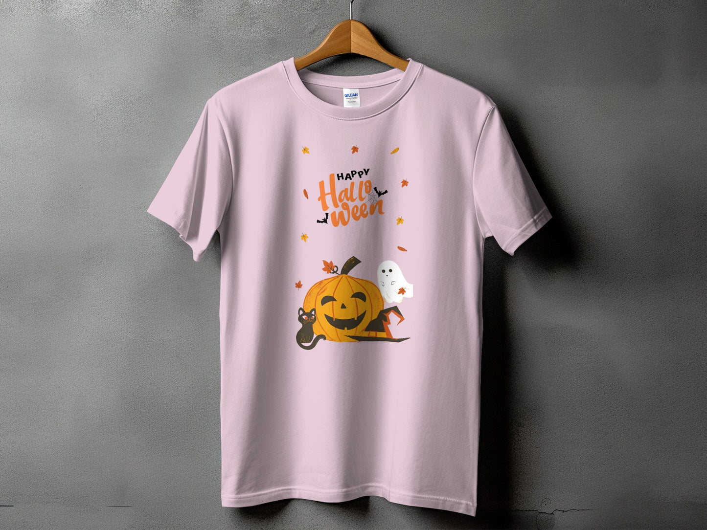 Pink t-shirt with "Happy Halloween" text and pumpkin, cat, ghost, and hat graphics.