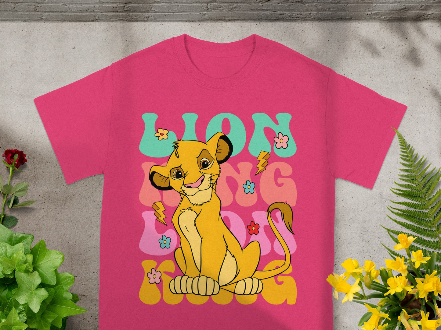 Simba from The Lion King smiling with colorful text and lightning bolts.