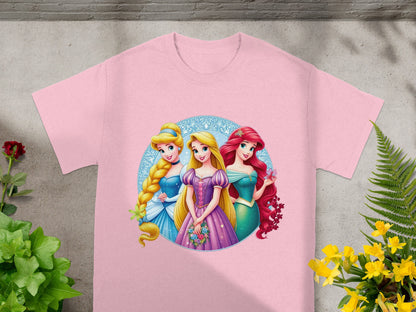Three Disney princesses, Cinderella, Ariel, and Rapunzel, on a pink t-shirt.