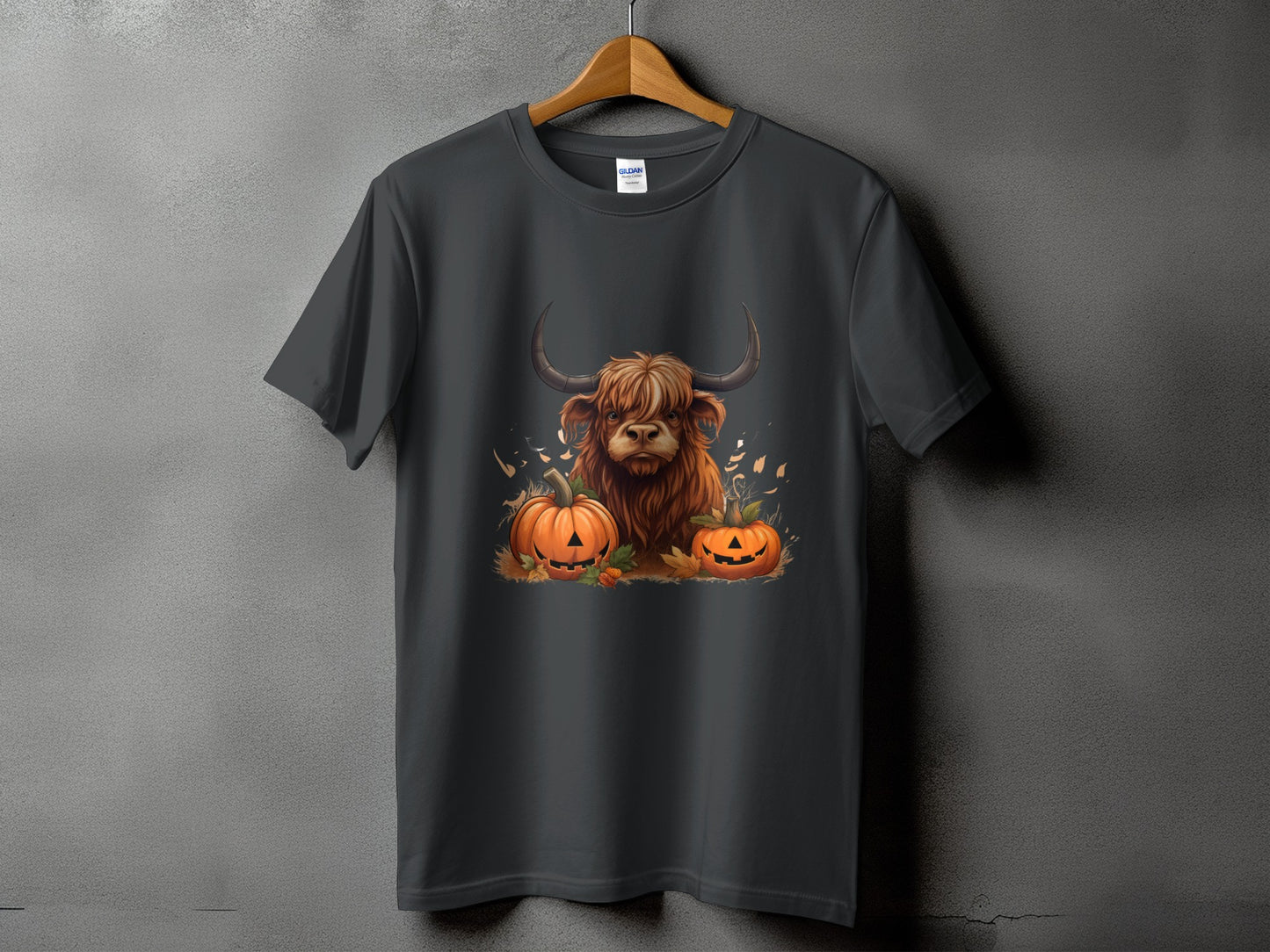 Dark gray t-shirt featuring a Highland cow with pumpkins and fall leaves graphic.