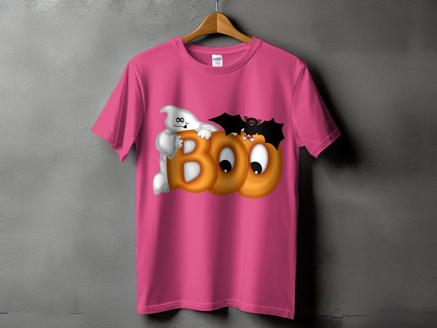 Pink t-shirt with cartoon ghost, bat, and "BOO" text graphic for Halloween.
