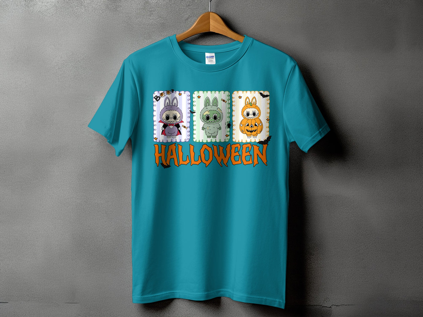 Teal t-shirt with three Halloween bunny characters and the word "HALLOWEEN".