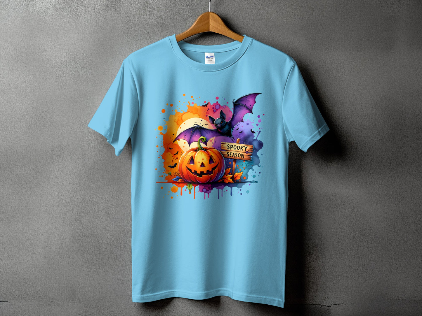 Light blue t-shirt with Halloween graphic: pumpkin, bat, moon, and "Spooky Season" sign.