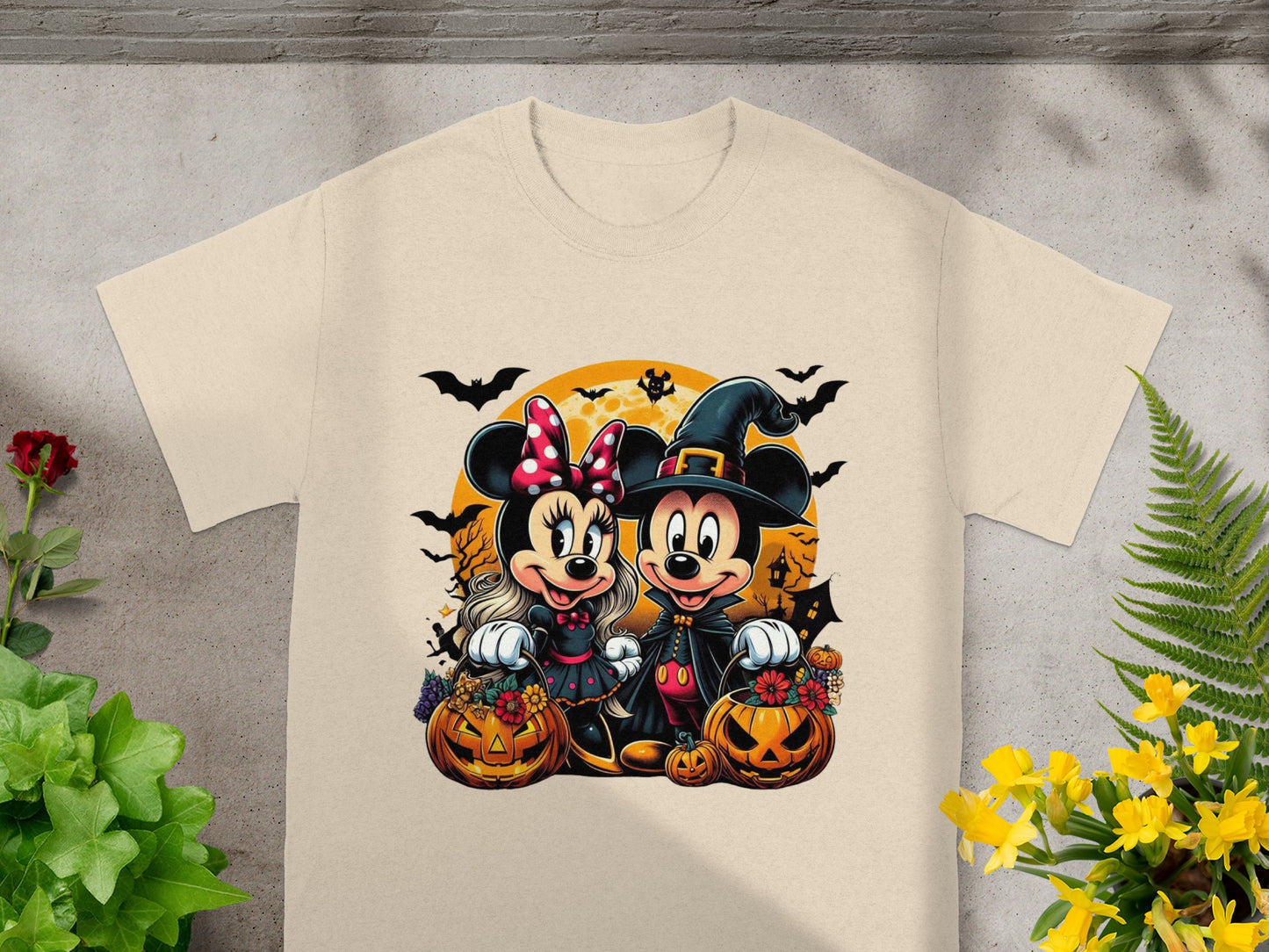 Minnie and Mickey Mouse in Halloween costumes with pumpkins and bats.