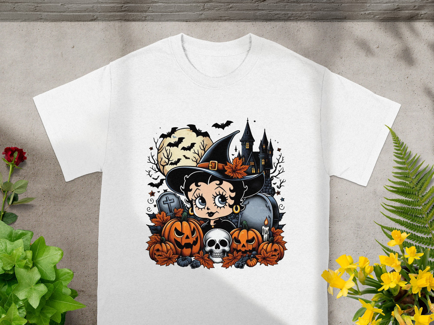 Betty Boop witch costume with pumpkins, skull, graveyard, and haunted house.
