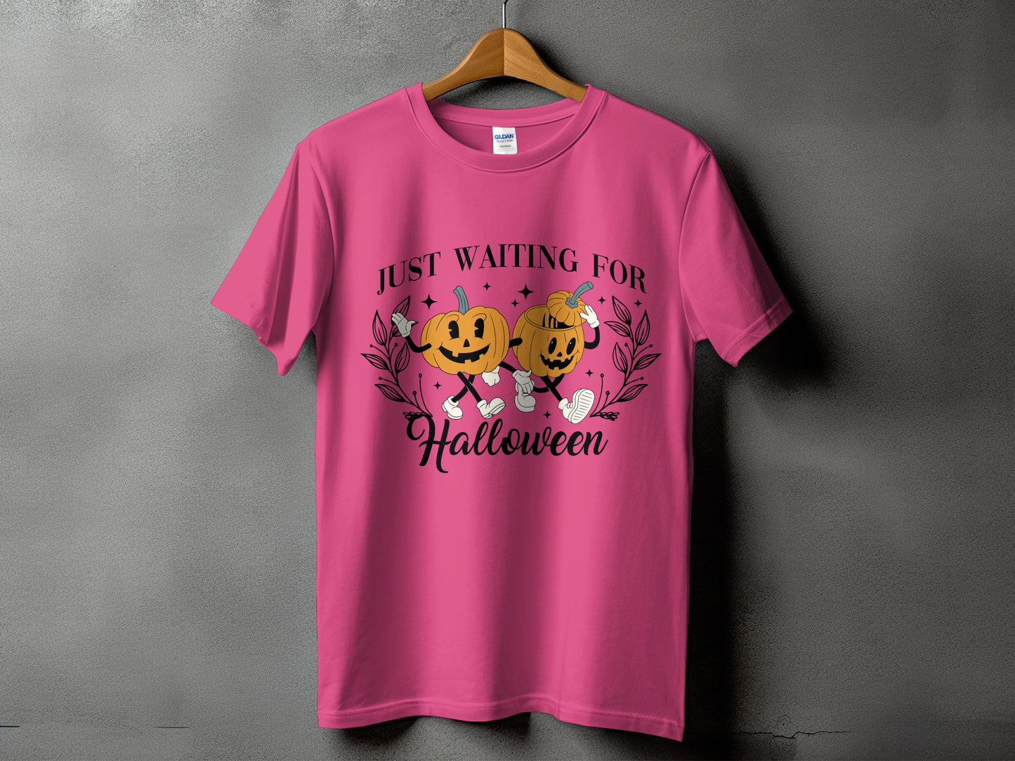 Pink t-shirt with graphic of two pumpkins saying "JUST WAITING FOR Halloween".