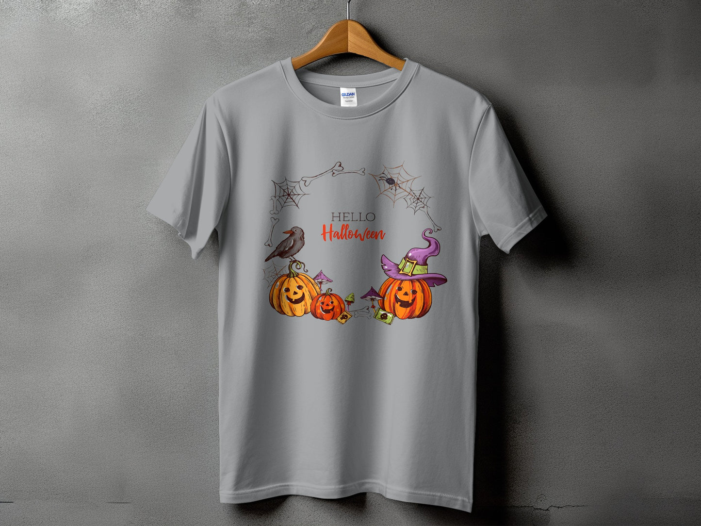 Grey t-shirt with a Halloween graphic featuring pumpkins, a crow, and a spiderweb wreath.
