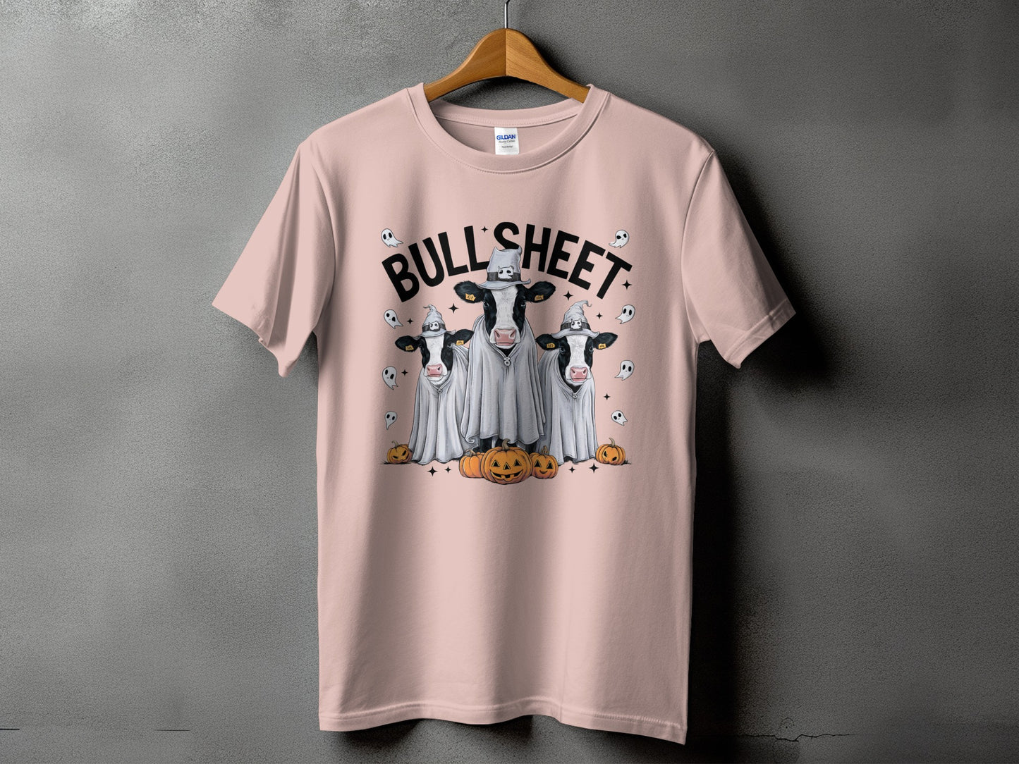 Pink t-shirt with three cows in ghost costumes and pumpkins.