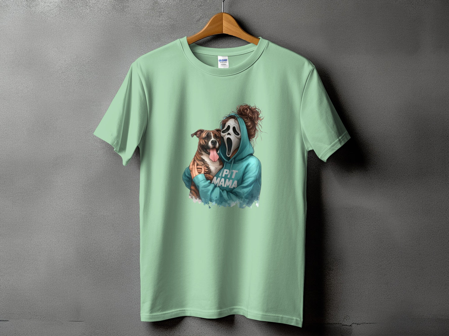 Green t-shirt with a graphic of a person in a Scream mask holding a pit bull dog.