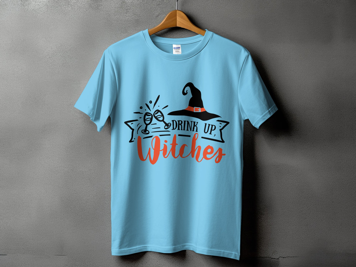 Light blue t-shirt with black witch hat and "Drink Up, Witches" text.
