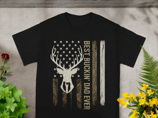 Black t-shirt with a deer skull, stars, and American flag stripes saying "BEST BUCKIN' DAD EVER".