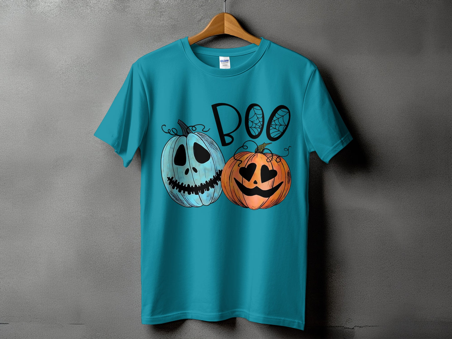Teal t-shirt with "Boo" text and two jack-o'-lanterns, one blue and one orange.