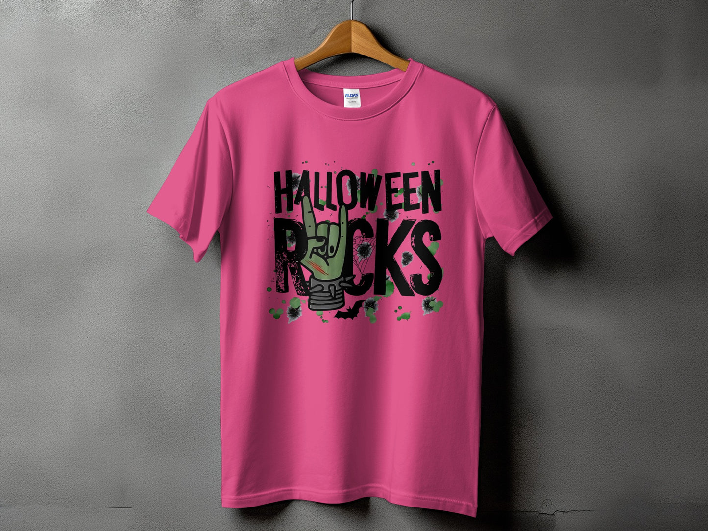 Pink t-shirt with green zombie hand and "Halloween Rocks" text
