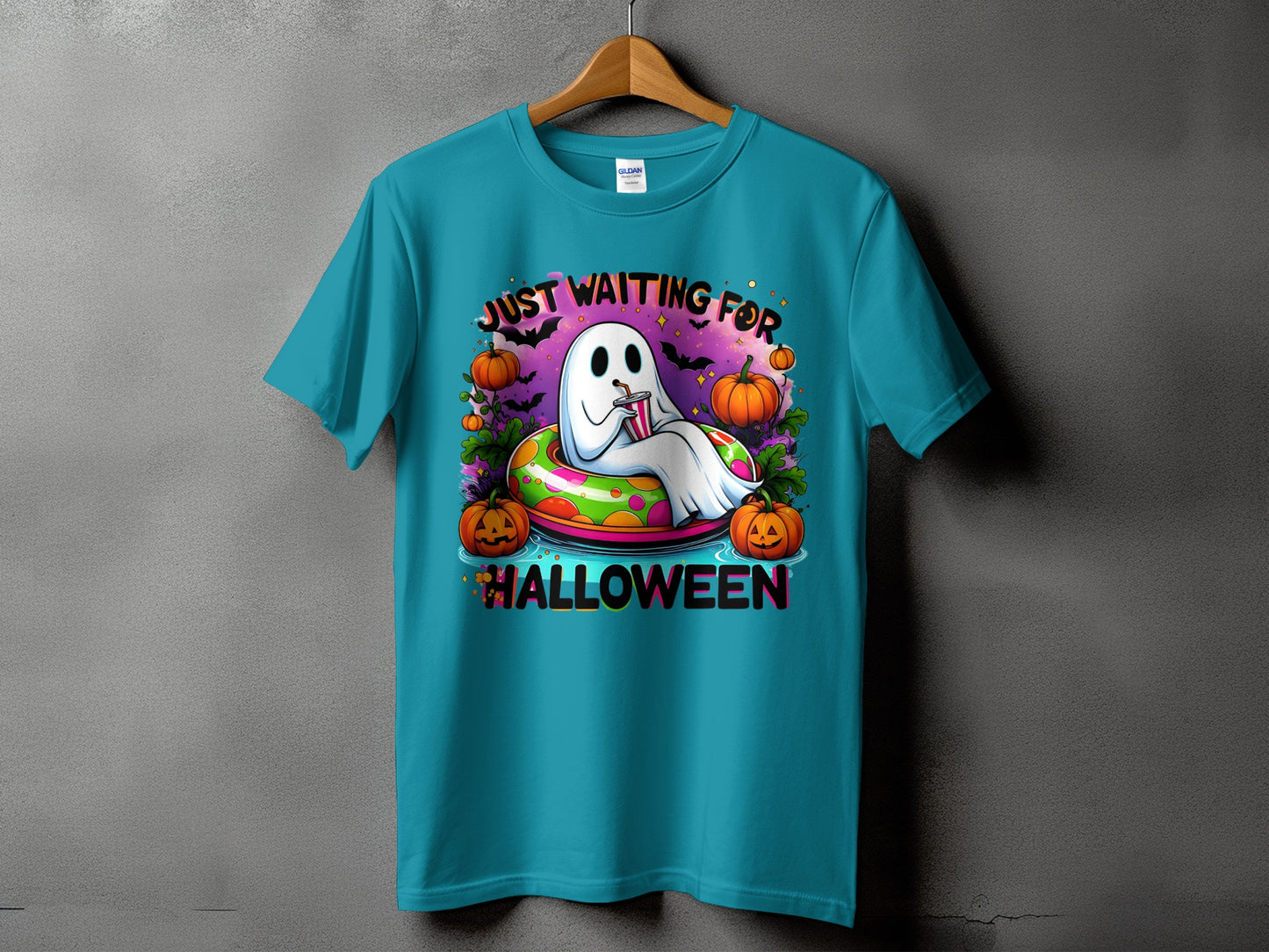 Teal t-shirt with ghost and pumpkins graphic saying "Just waiting for Halloween".