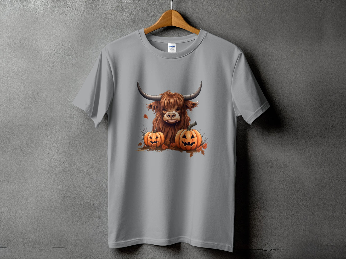 Grey t-shirt with Highland cow and two jack-o'-lanterns graphic.
