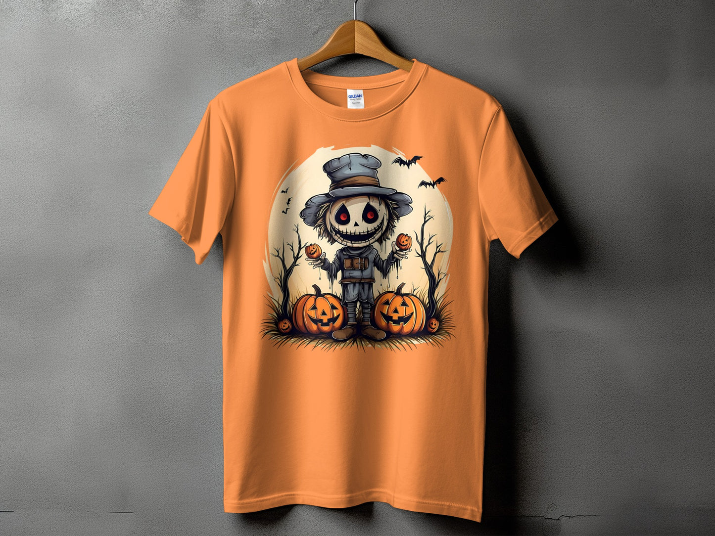 Orange t-shirt with a spooky scarecrow holding pumpkins and bats.