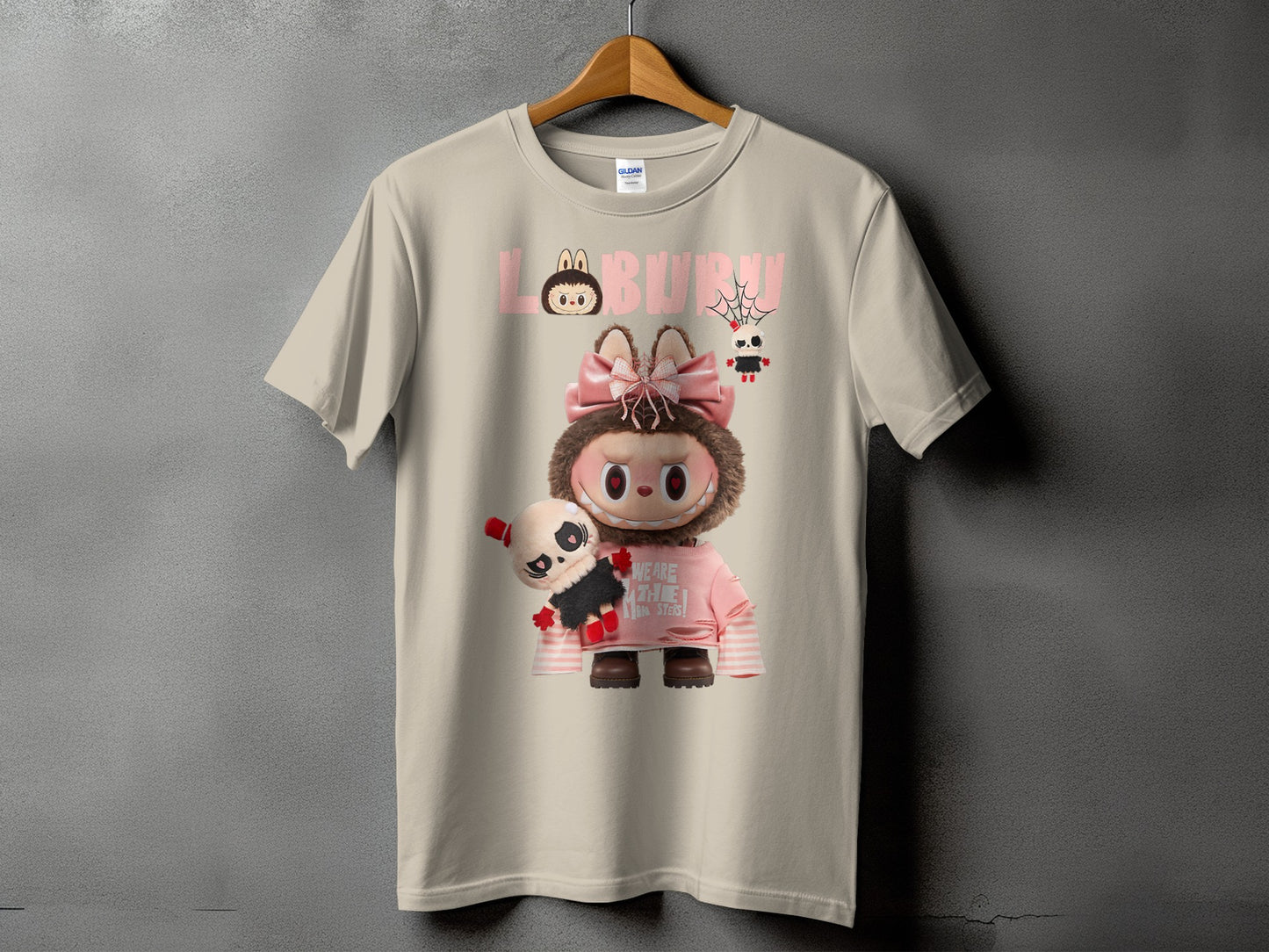 Tan t-shirt with "LABURUN" text and a character holding a skull plush.
