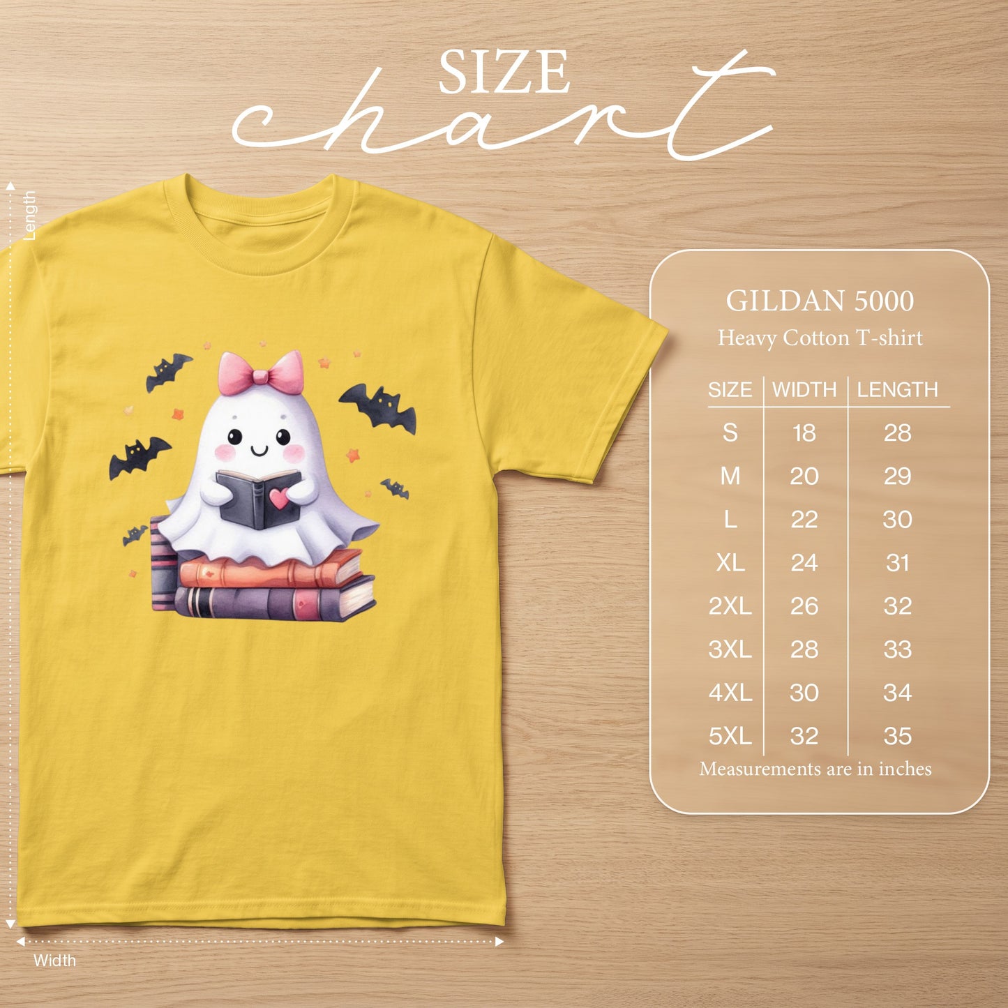 Yellow t-shirt with a cute ghost reading a book, surrounded by bats. Size chart included.