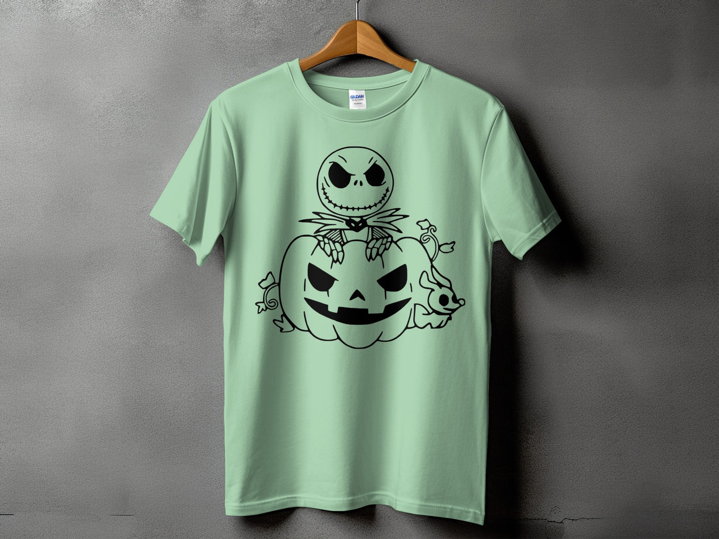 Mint green t-shirt with black graphic of Jack Skellington on a pumpkin.