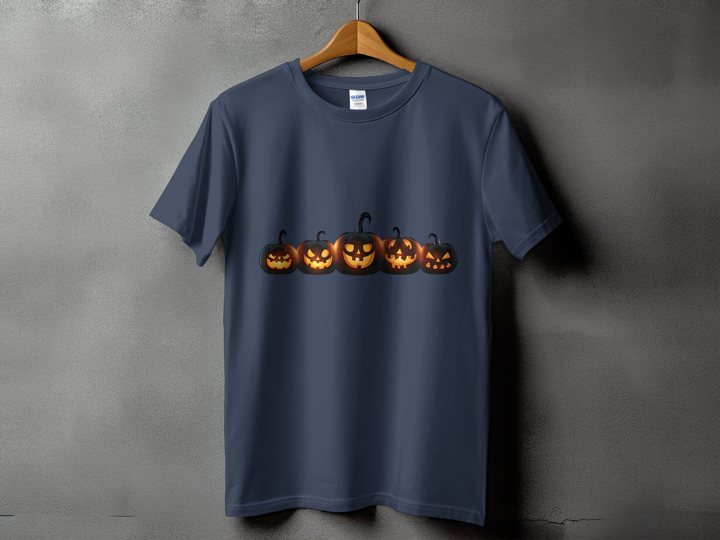 Dark blue t-shirt featuring a row of five glowing jack-o'-lanterns.