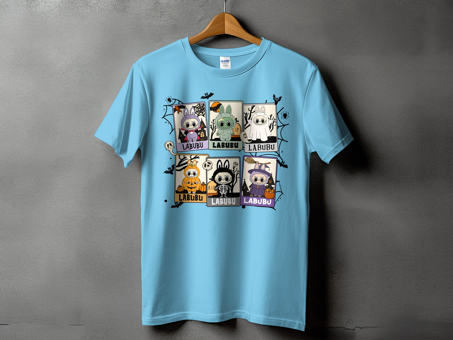 Light blue t-shirt with six cartoon Halloween character squares, each labeled "LABUBU".