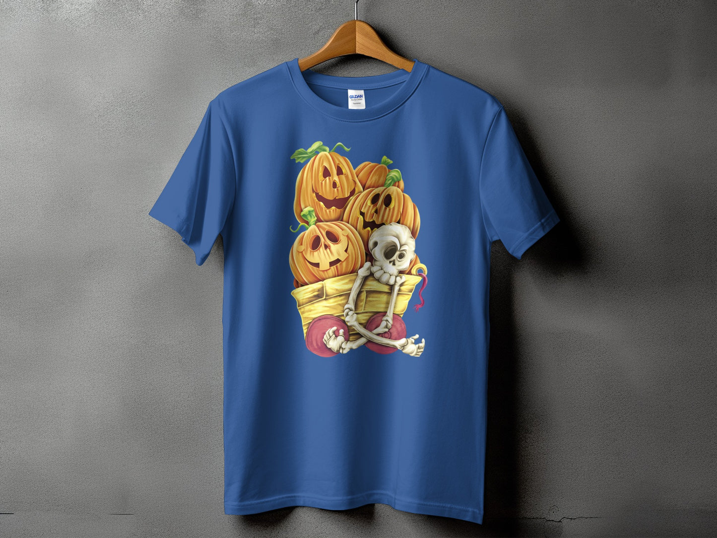 Blue t-shirt with pumpkins and skeleton in a wagon graphic.