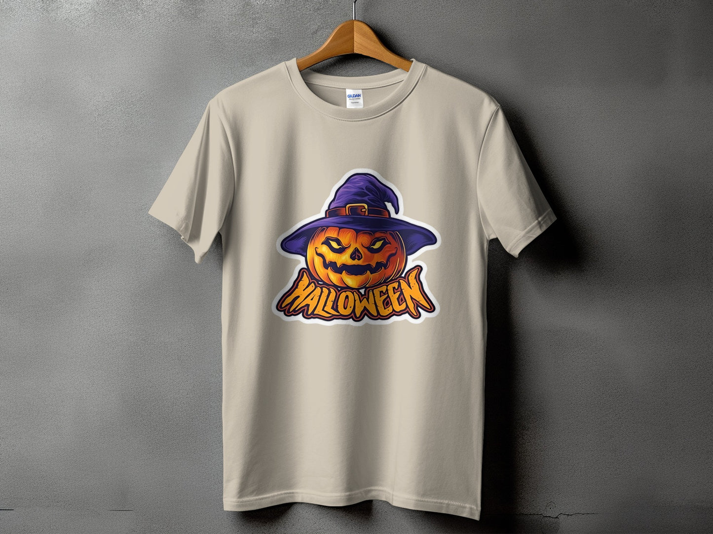 Tan t-shirt with a Halloween pumpkin wearing a witch hat graphic and text.