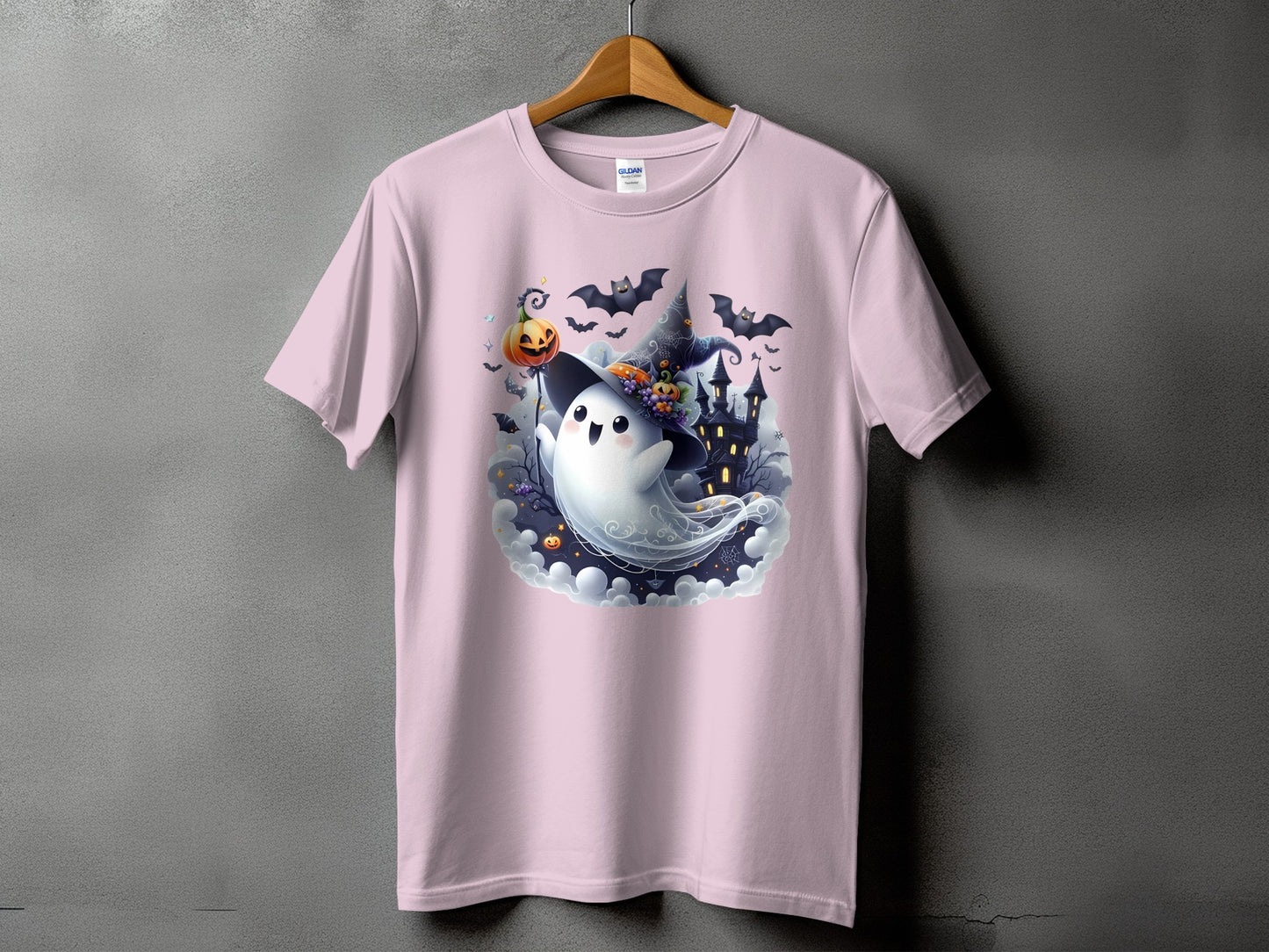 Pink t-shirt with a cute ghost wearing a witch hat and holding a pumpkin.