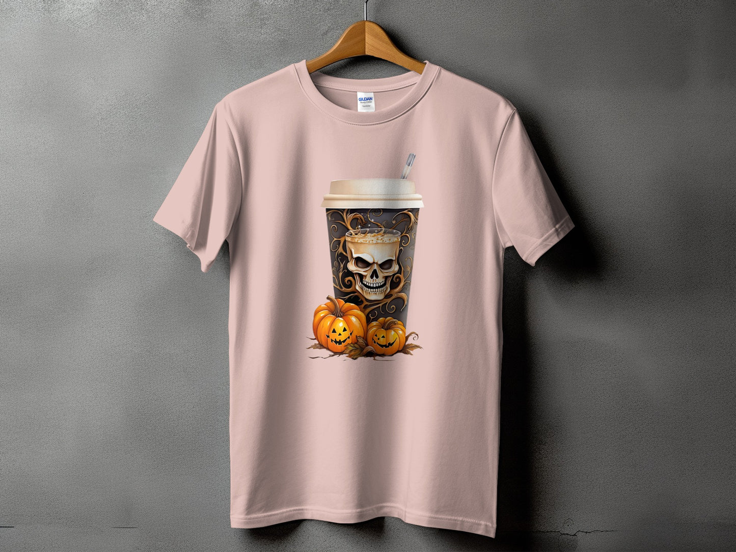 Pink t-shirt with a coffee cup design featuring a skull and pumpkins.