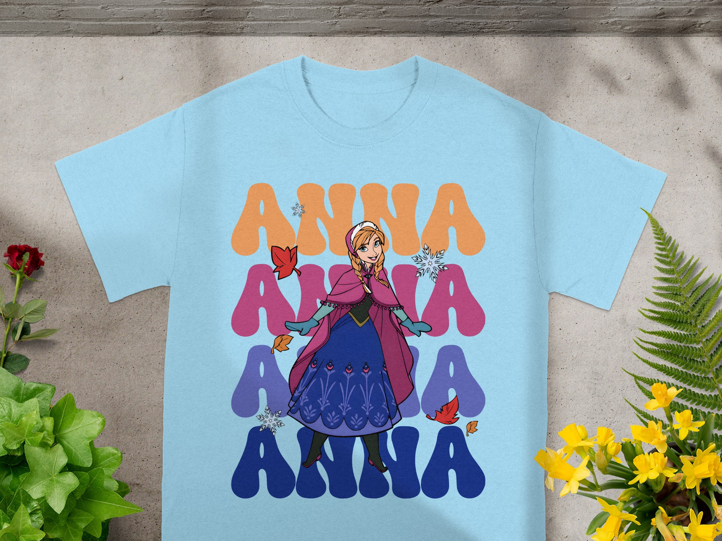 Light blue t-shirt with colorful Anna from Frozen graphic.