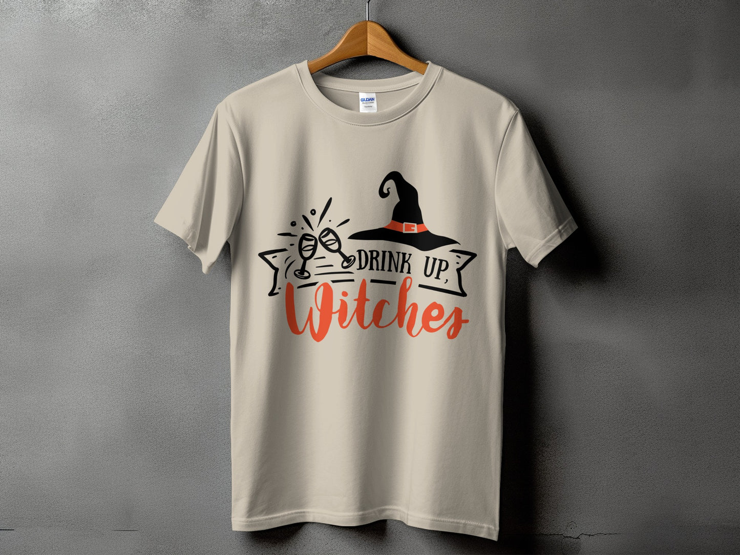 Cream t-shirt with black witch hat, clinking glasses, and text "DRINK UP, Witches".