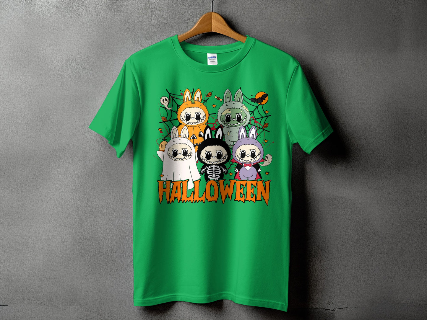Green t-shirt with cartoon Halloween characters and text.