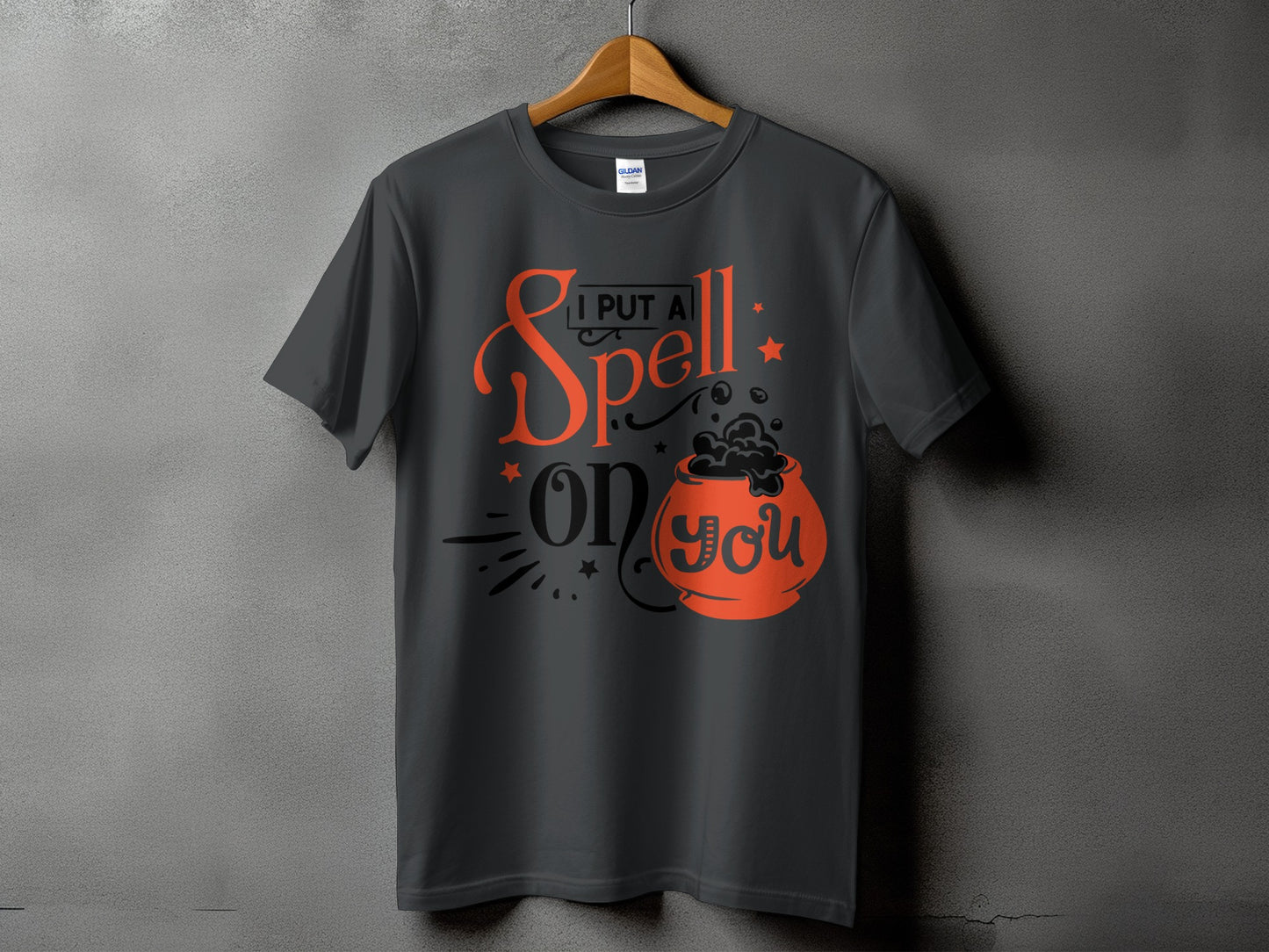 Dark gray t-shirt with "I put a spell on you" Halloween graphic and cauldron.