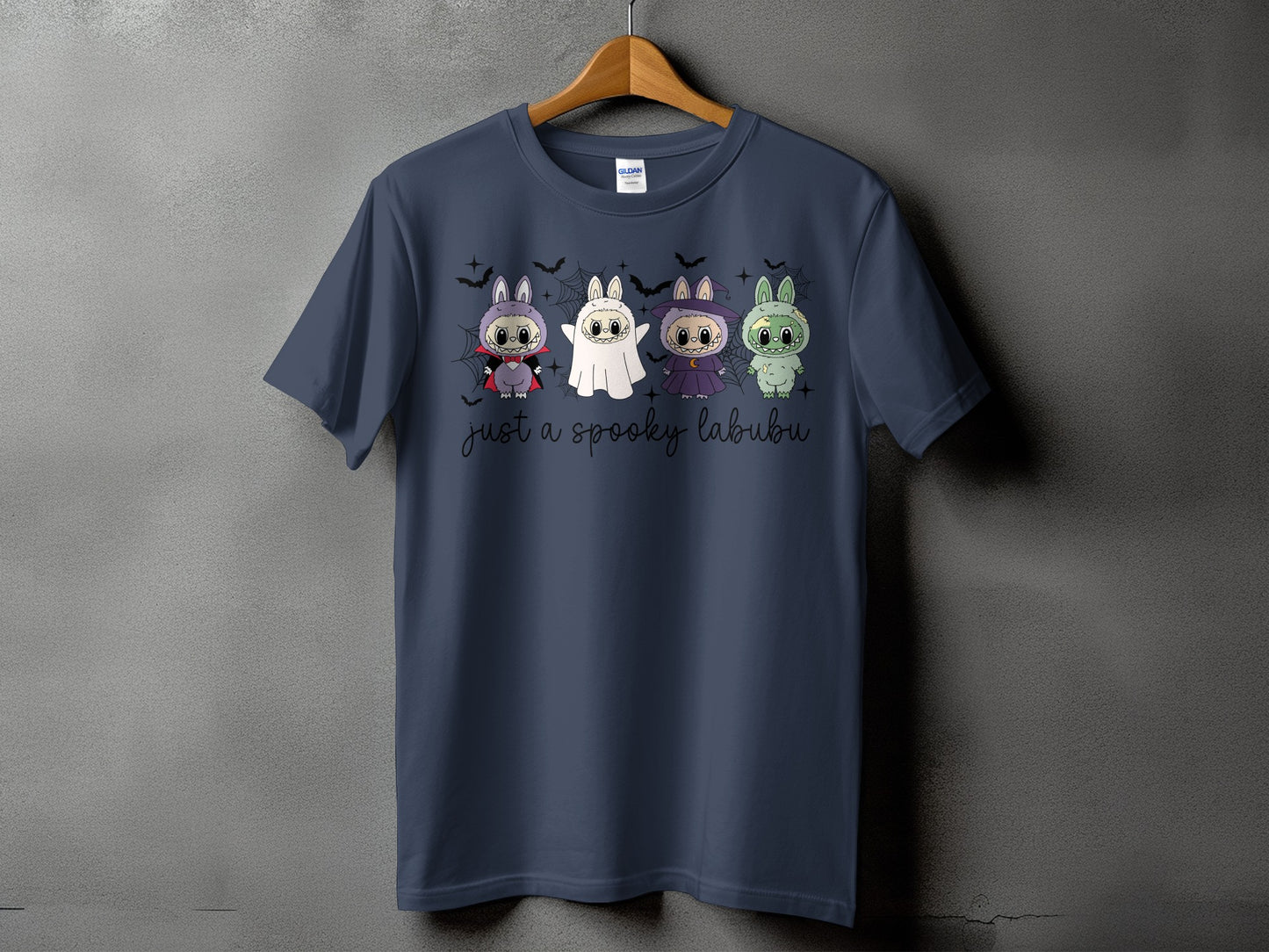 Dark blue t-shirt with four Halloween-themed Labubu characters and text.