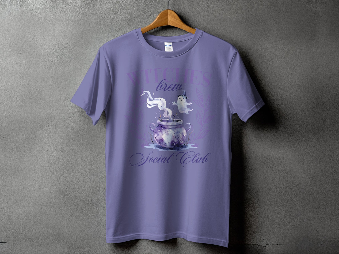Purple t-shirt with "Witches Brew Social Club" text and cauldron graphic.