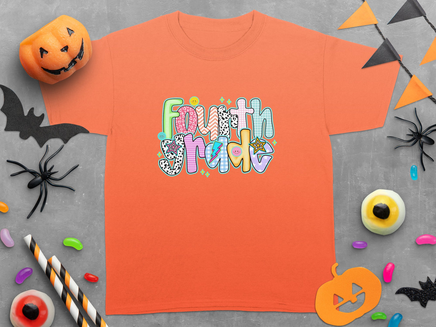 Orange t-shirt with colorful "Fourth Grade" graphic and Halloween decorations.