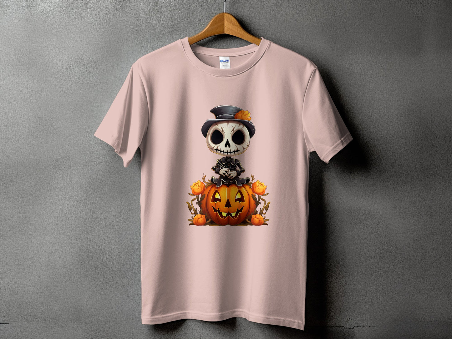 Pink t-shirt with a Halloween skeleton character on a pumpkin design.