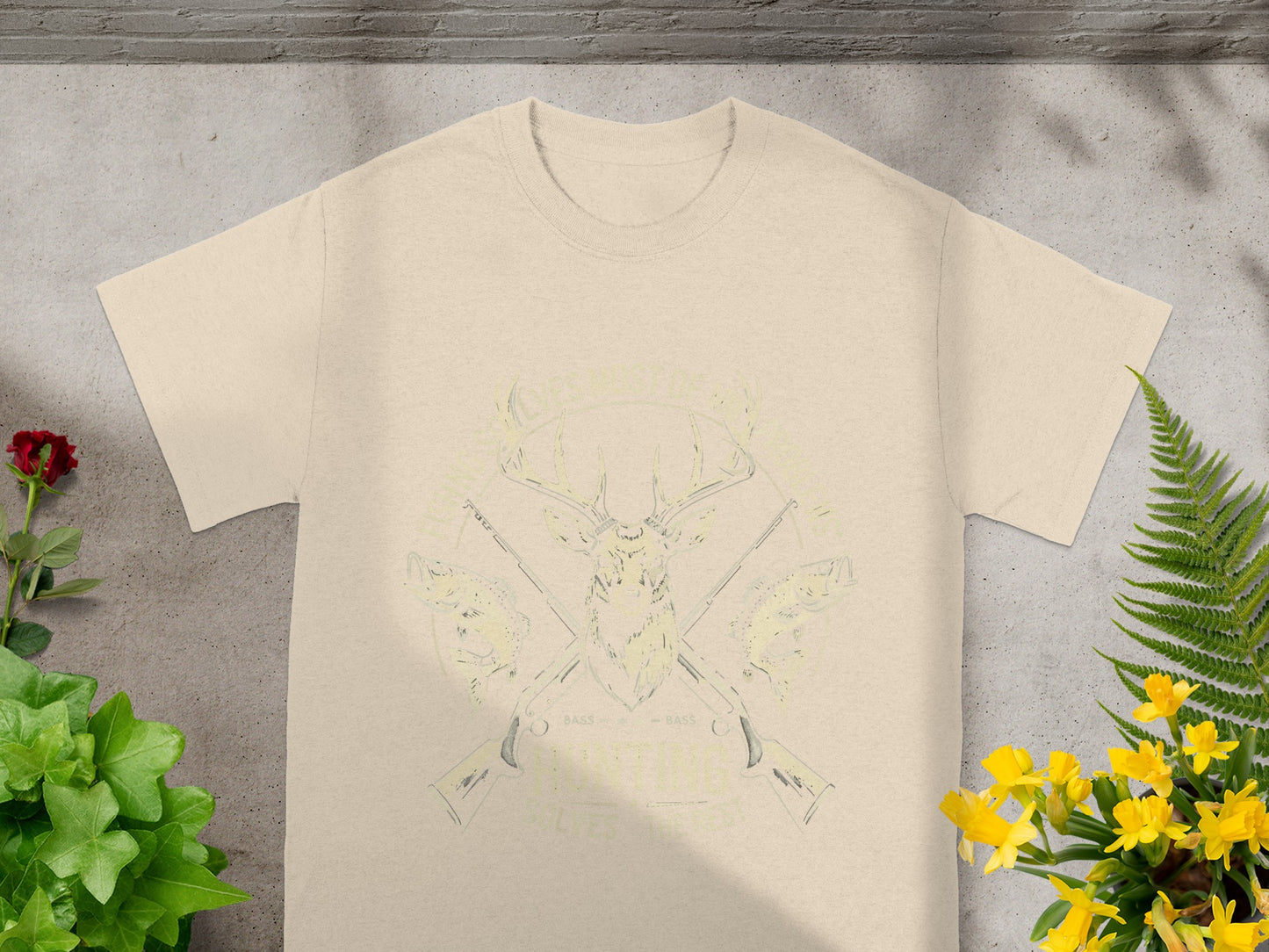 Cream t-shirt with deer, fish, and rifles graphic and text.